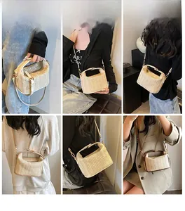 Multiple carrying styles of straw crossbody bag with white, tan and brown trim details