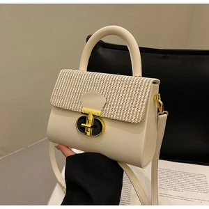 Chic cream crossbody bag with woven flap detail and gold clasp shown from a 45-degree angle