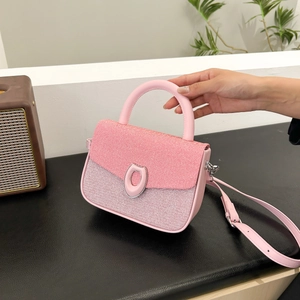Pink shoulder bag with red knit flap and silver oval buckle on dark leather base