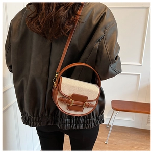 Classic canvas saddle bag with brown leather trim and metal buckle for women