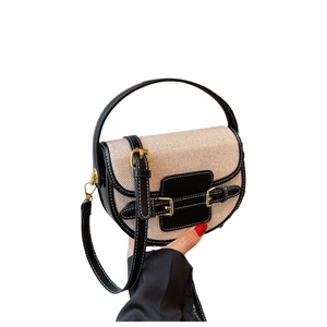 Retro beige canvas and black leather saddle bag with gold buckles and top handle