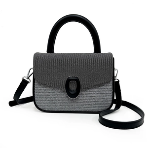 Modern two-tone underarm bag with silver grey textured fabric and black leather handle