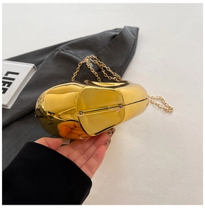 Detailed side view of luxury gold metallic acrylic clutch with stone pattern and chain