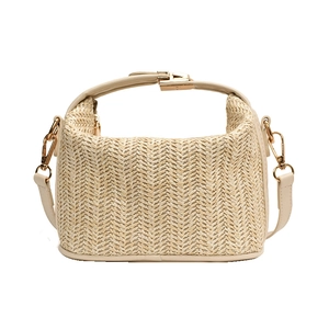 Beige straw woven handbag with top handle and adjustable strap for summer vacations