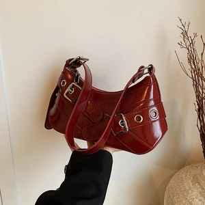 Deep red vintage patent leather baguette shoulder bag with stylish buckles and metal eyelets
