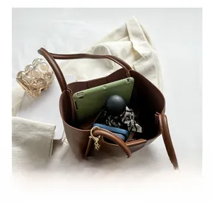 Brown leather tote bag interior showing large capacity for tablet and wallet