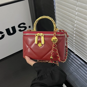 Quilted red leather mini box bag with gold chain strap and floral accent