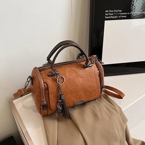 Caramel vintage Boston bag with cat tassel charm and adjustable long shoulder strap