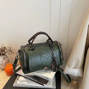 Vintage dark green Boston bag in pebbled leather with tassel charm and shoulder strap