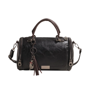 Vintage Boston bag with cat pendant and tassel, stylish black and brown shoulder bag