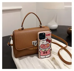 Brown PU handbag size comparison with phone showing vertical embossed texture and lock