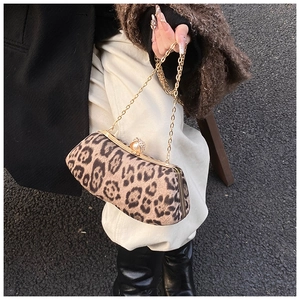Detail of leopard print clutch with pearl rhinestone clasp and gold chain strap