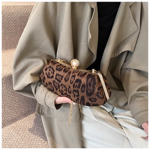 Detail of leopard print clutch with pearl rhinestone clasp and gold chain strap