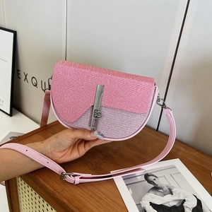 Chic pink glitter crossbody bag with semi-circular design and silver metallic clasp