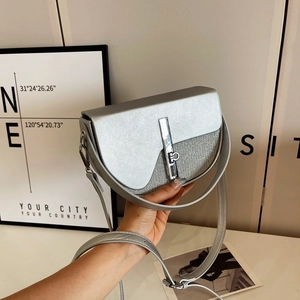 Silver grey saddle bag with sleek leather texture and sparkling fabric detail