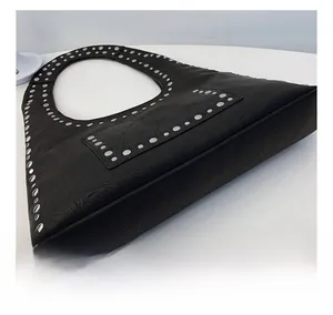 Detail shot of the black leather hobo bag with silver studs and wrinkled texture