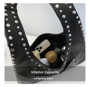 Internal capacity of the black hobo bag with rivets showing space for daily essentials