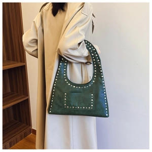 Detail of dark green hobo bag with vintage texture and silver rivet studs