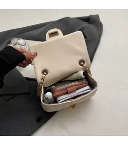 Interior view of white quilted crossbody bag showing spacious storage for essentials