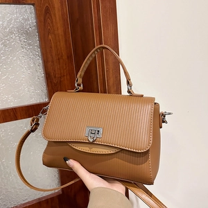 Brown textured leather handbag with silver lock and adjustable shoulder strap for women