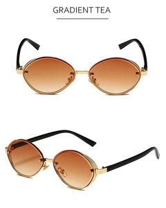 Detail view of oval cat-eye sunglasses with gradient tea lenses and gold metal frame