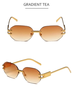 Detail of rimless polygon sunglasses with gradient tea lenses and gold textured arms