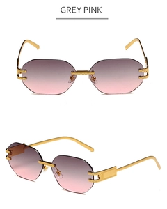 Detail of rimless hexagonal sunglasses with grey pink gradient lenses and gold metal frame
