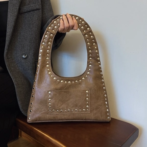 Vintage brown leather hobo bag with silver rivet studs and stylish shoulder strap