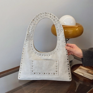White rivet shoulder bag with silver studs and pebble leather texture for women