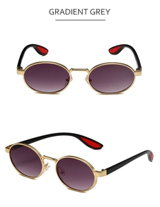Detail view of oval metal sunglasses with gradient grey lenses and gold frames