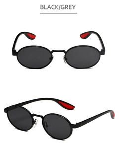 Detail view of oval sunglasses featuring black frames and distinctive red non-slip temple tips