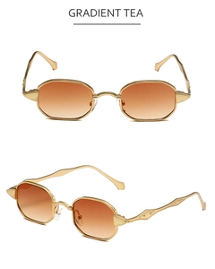 Detailed view of retro polygon sunglasses with golden metal frame and gradient tea lenses