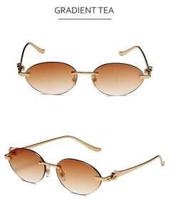 Détail de lunettes de soleil ovales sans monture, verres dégradés et branches dorées