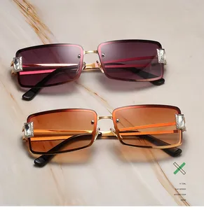 Detail of square rimless sunglasses with gold metal frame and rhinestone embellishments