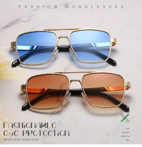 Detail of metal aviator frames with blue and orange lenses on marble background