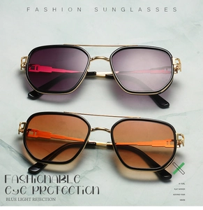 Detail of aviator glasses frames featuring golden metal hinges and cut-out craftsmanship