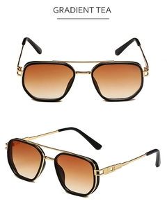 Detail of gradient tea lenses and gold metal frame on double bridge sunglasses