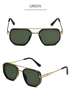 Detail view of gold aviator sunglasses with green lenses and textured metal temples