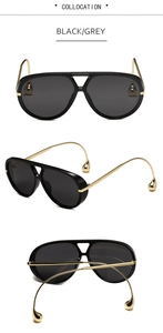 Detalle de gafas de sol piloto oversize con patillas doradas y adornos de gotas