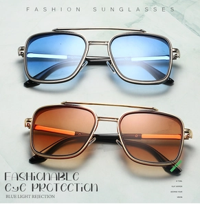 Close-up of double-bridge pilot sunglasses with silver and gold metal frames