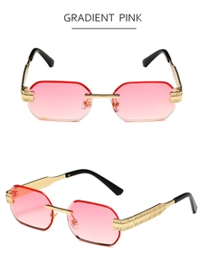 Close-up of gradient pink rimless sunglasses with ornate gold metal temples and frames