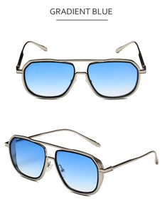Dettaglio di occhiali da sole vintage con montatura in metallo argento e lenti blu sfumate