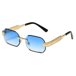 Modern rimless polygon sunglasses with blue gradient lenses and carved gold metal temples