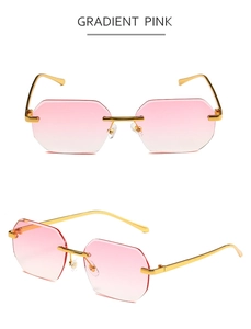 Detail van een randloze achthoekige zonnebril met roze glazen en een goudmetalen frame