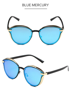 Detail of blue mercury cat-eye sunglasses with black frame and gold metal accents