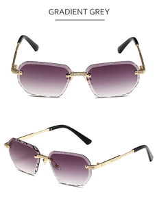 Detail of rimless polygon sunglasses featuring gradient grey lenses and gold metal frames