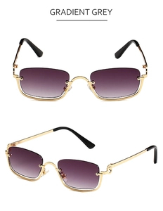 Detail view of small rectangular sunglasses with gold metal frame and gradient grey lenses