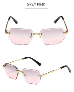 Detail of grey pink gradient rimless sunglasses with diamond cut edge and gold frame