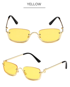 Detailed view of rectangle rimless sunglasses with yellow lenses and gold metal frame