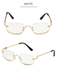 Detail of gold metal half-frame sunglasses with white rectangular lenses and black tips